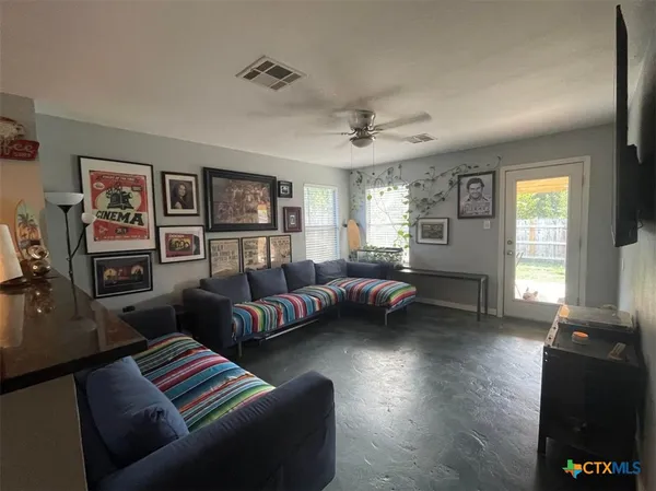 a living room with furniture and a flat screen tv