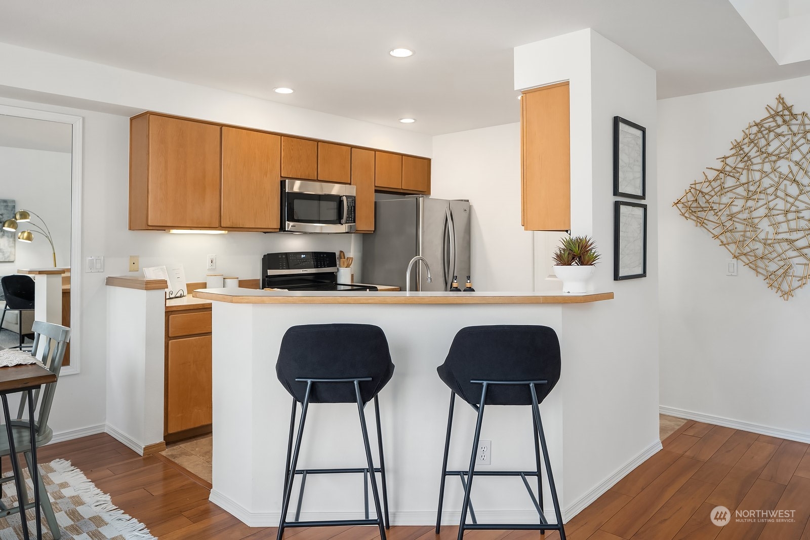 1925 187th Place Southeast Bothell, WA 98012 - Photo 12 of 30 a kitchen with stainless steel appliances a stove a sink a microwave a refrigerator and chairs