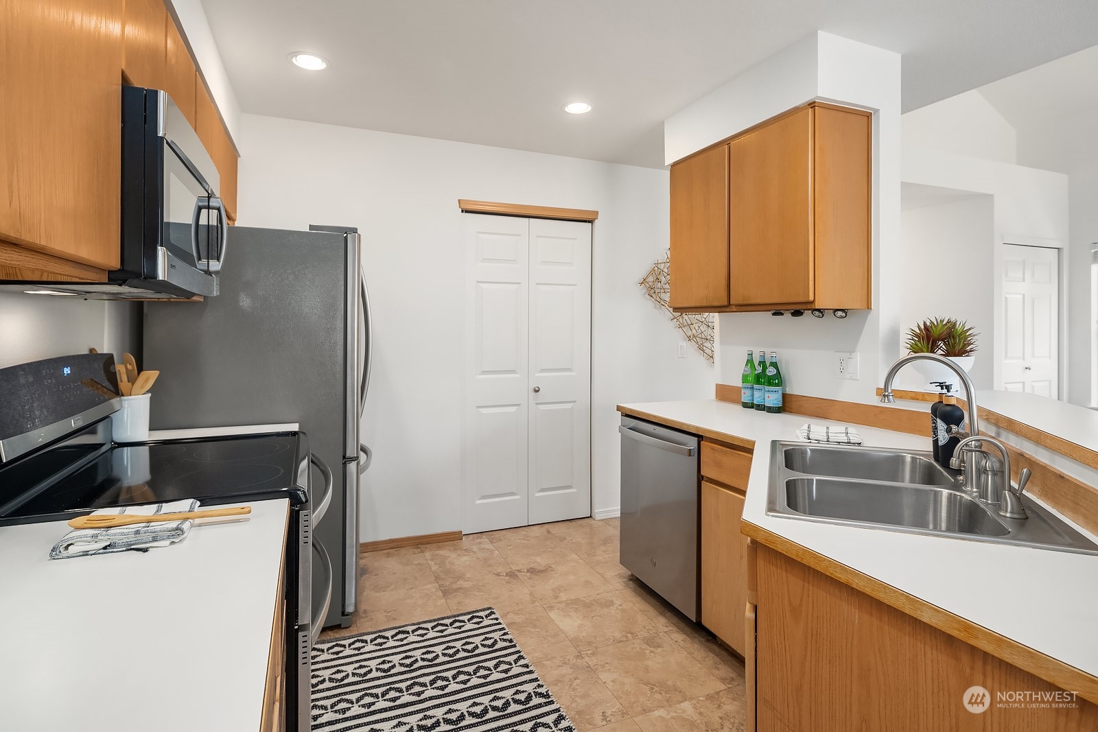 1925 187th Place Southeast Bothell, WA 98012 - Photo 13 of 30 a kitchen with stainless steel appliances a refrigerator sink and microwave