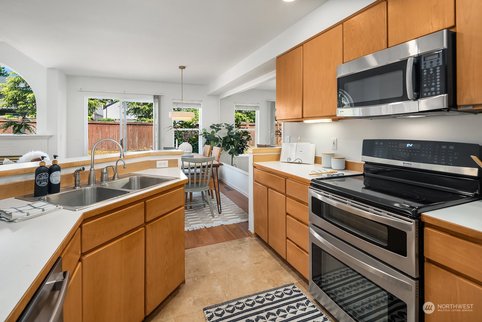 1925 187th Place Southeast Bothell, WA 98012 - Photo 14 of 30 a kitchen with stainless steel appliances a stove sink microwave and cabinets