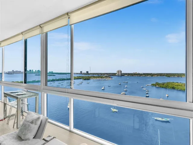 a living room with furniture and a floor to ceiling window