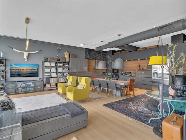 a living room with furniture and floor to ceiling window