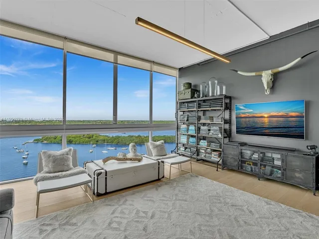 a living room with furniture and large window