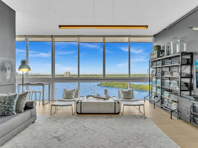 a living room with furniture and a floor to ceiling window