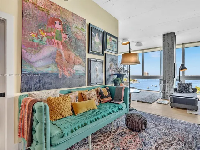 a bedroom with a bed and painting on the wall