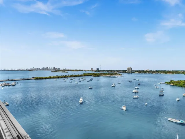 a bedroom with a bed and a chair in it