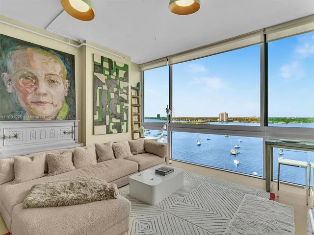 a bedroom with a bed and painting on the wall