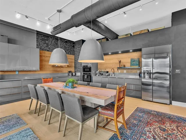 a kitchen with stainless steel appliances granite countertop a stove and a sink