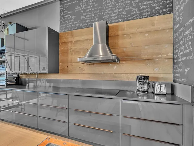 a kitchen with stainless steel appliances granite countertop a sink and stove