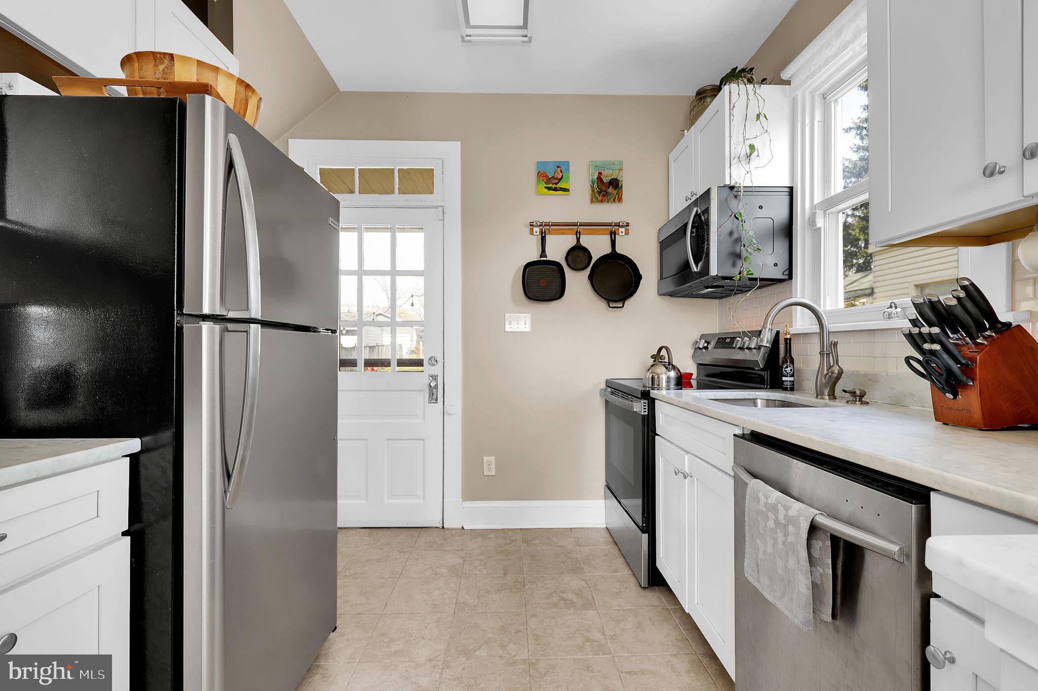 517 Fairview Avenue Frederick, MD 21701 - Photo 8 of 45 a kitchen with stainless steel appliances a refrigerator a sink a stove and cabinets