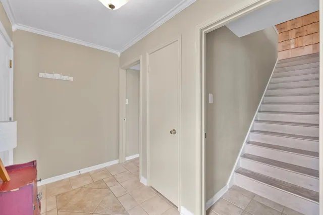 a view of a hallway with wooden floor and entryway