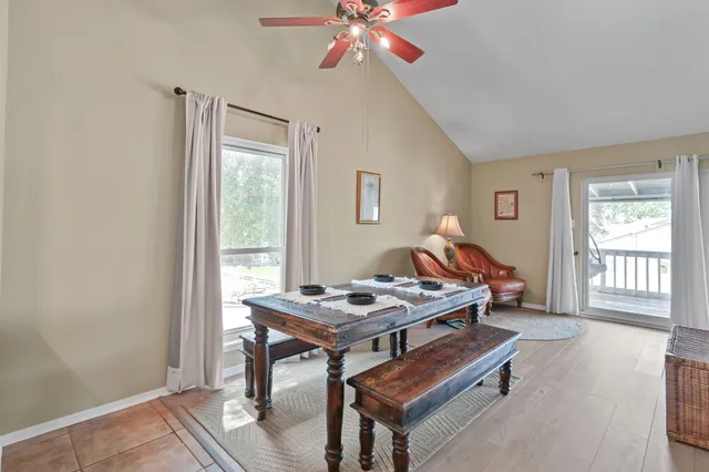 a living room with furniture a window and a potted plant