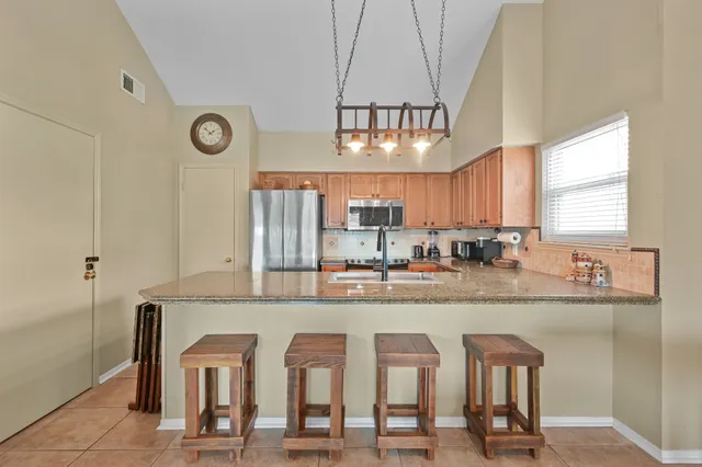 a kitchen with cabinets a sink and appliances
