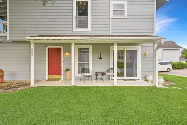 a front view of house with yard and outdoor seating