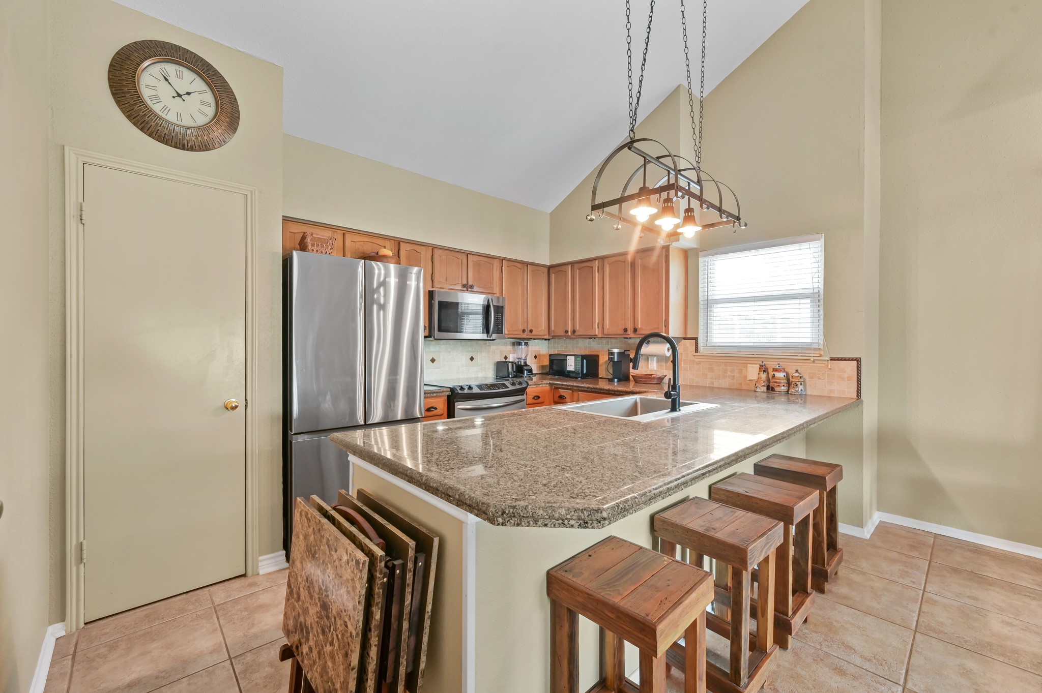 116 April Point Drive North Conroe, TX 77356 - Photo 31 of 44 a kitchen with a table and a refrigerator