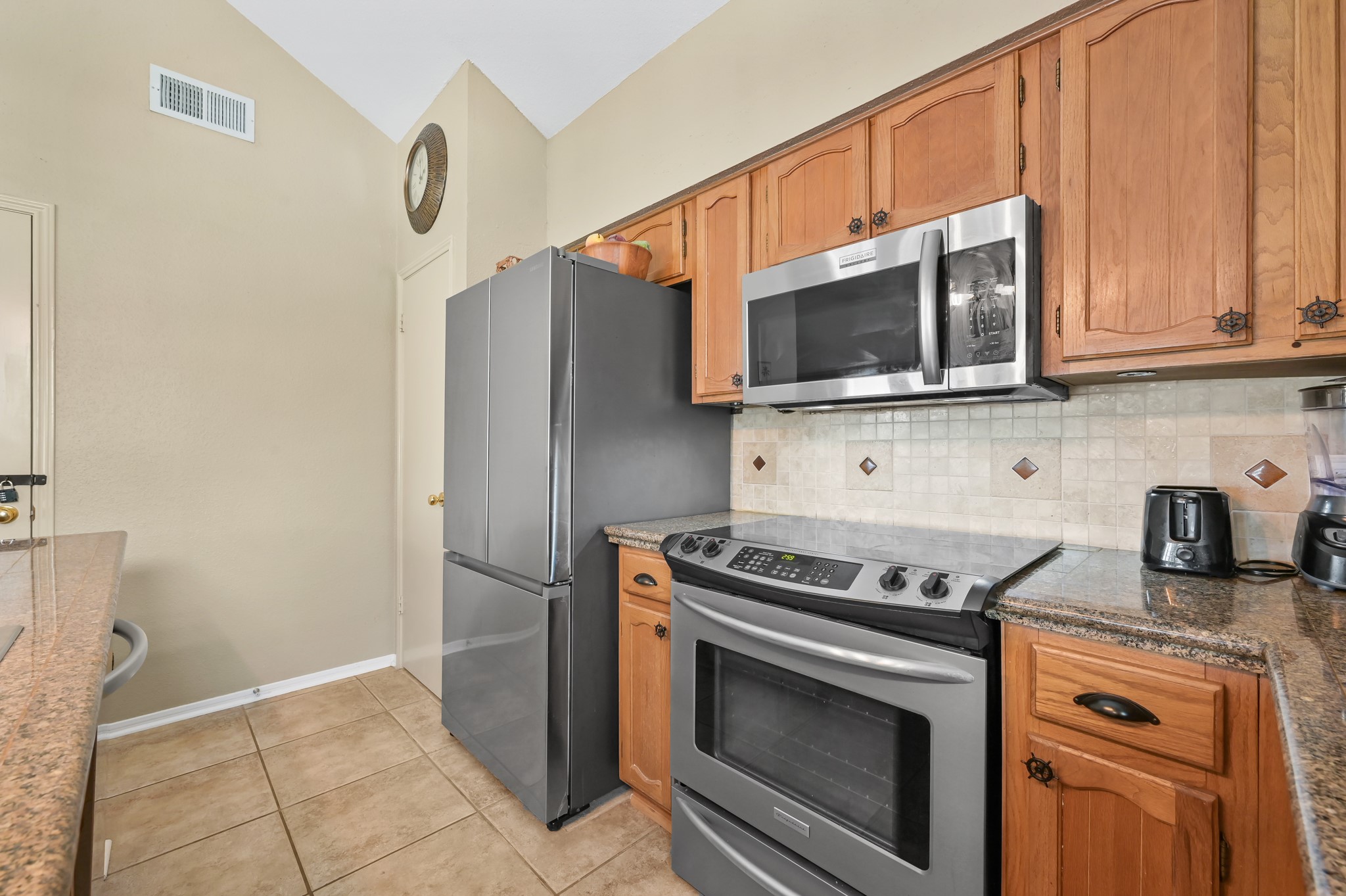 116 April Point Drive North Conroe, TX 77356 - Photo 35 of 44 a kitchen with granite countertop cabinets stainless steel appliances and a counter space