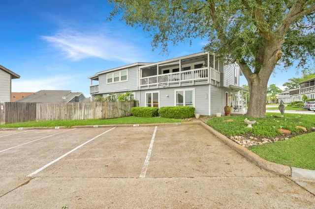 a view of a house with a yard and potted plants