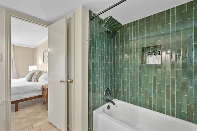 a bathroom with a bathtub and a shower