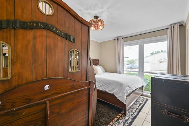 a bed sitting in a bedroom next to a window