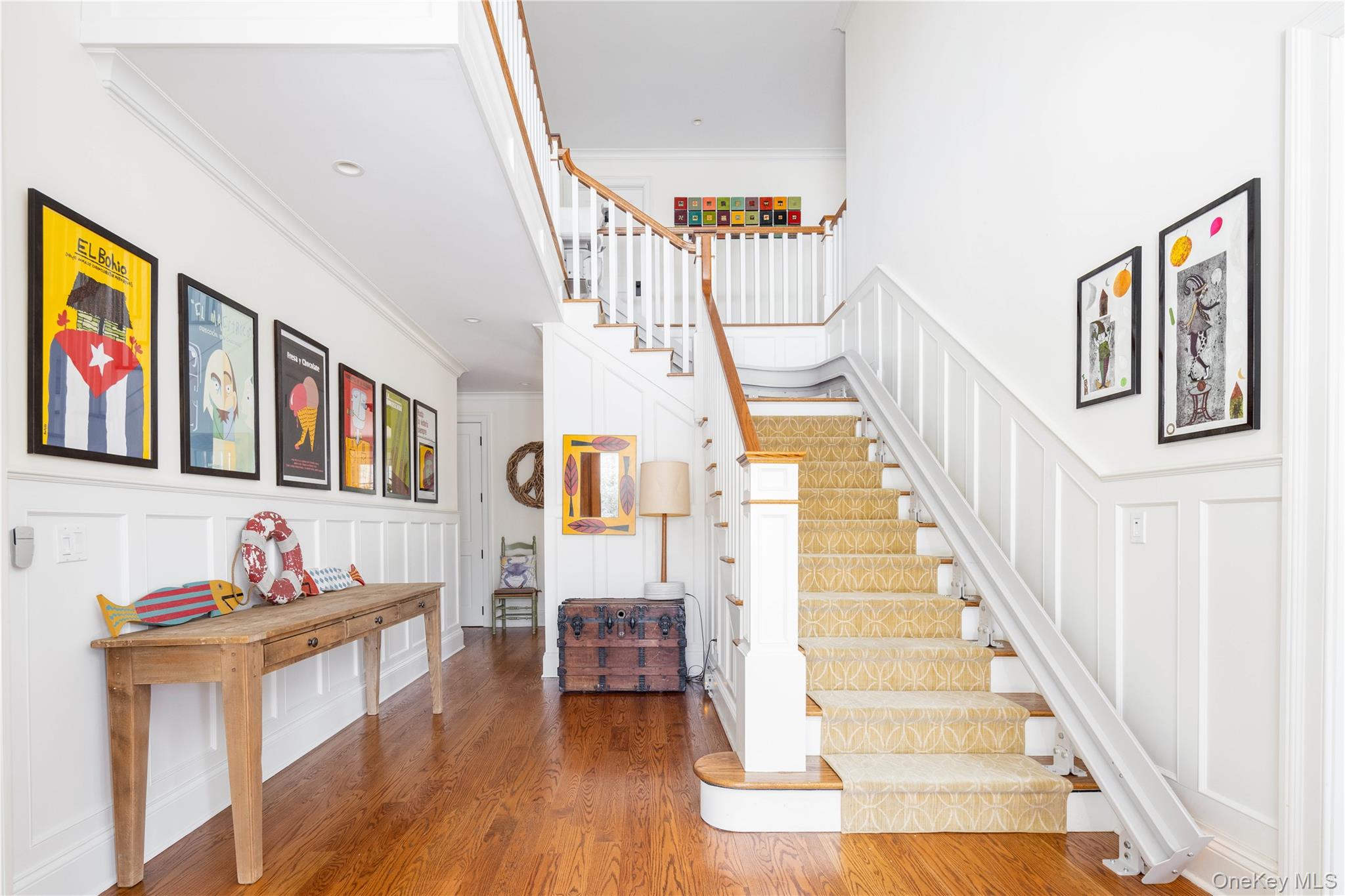 53 Cedar Lane West Remsenburg, NY 11960 - Photo 12 of 38 Staircase with wood finished floors, ornamental molding, and a decorative wall