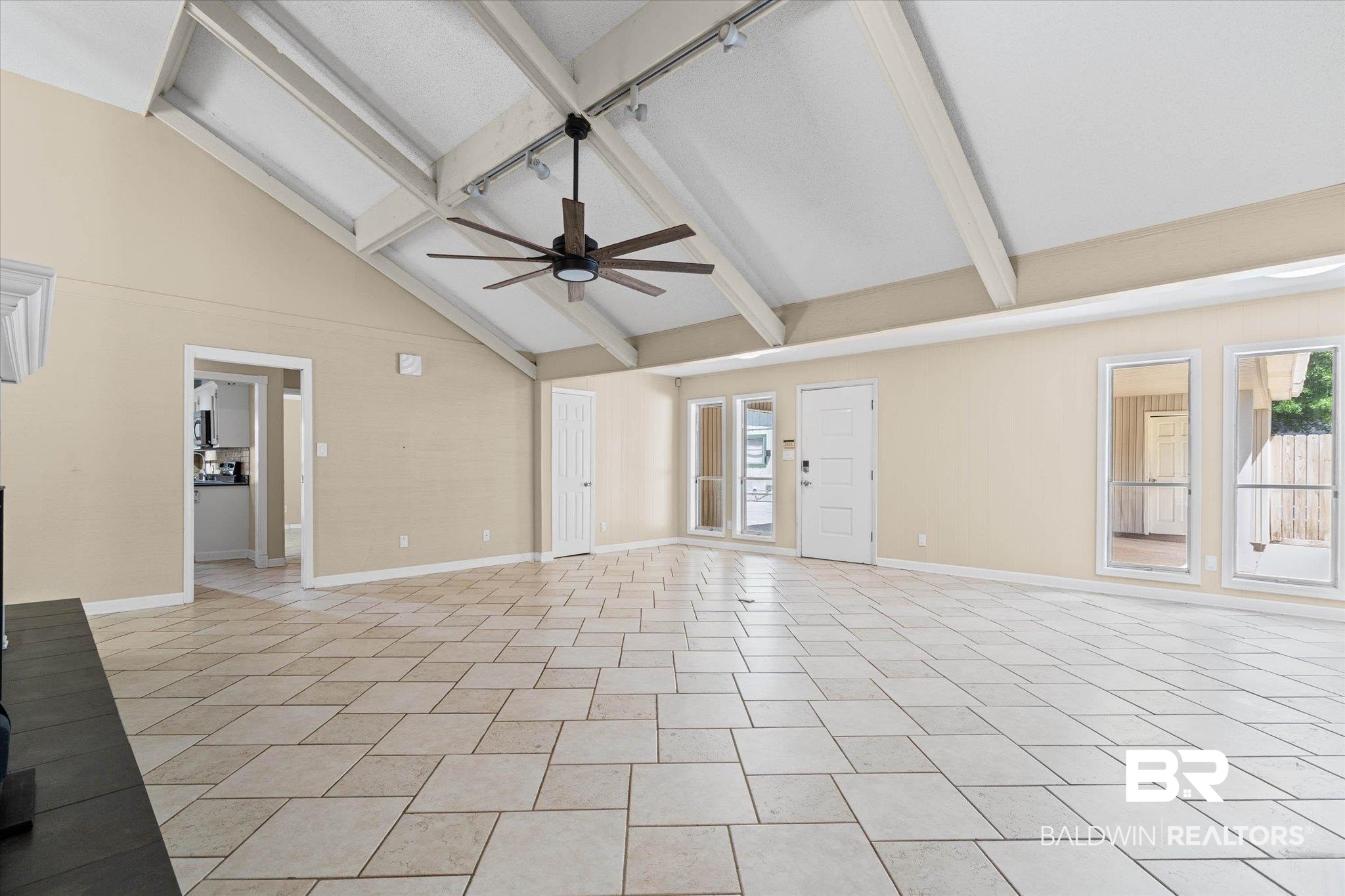 3724 Claridge Road South Mobile, AL 36608 - Photo 4 of 42 Unfurnished living room featuring vaulted ceiling, ceiling fan, and healthy amount of natural light