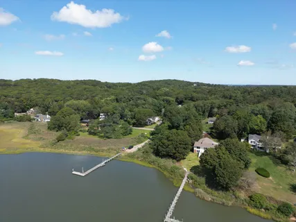 an aerial view of a houses with a yard