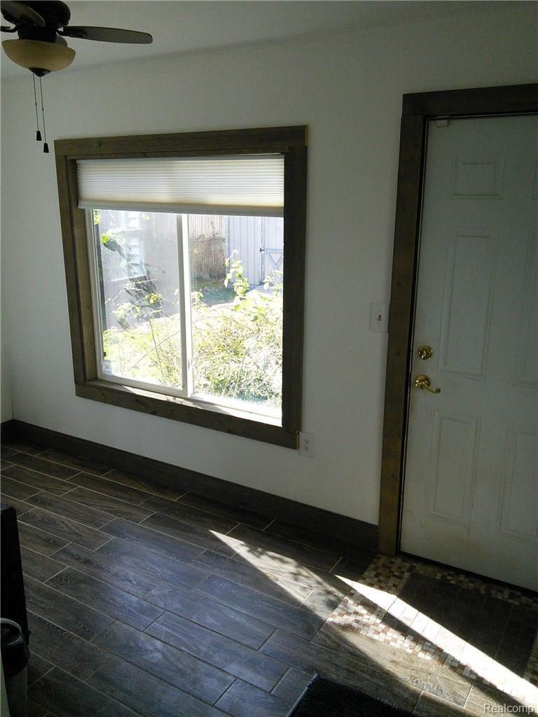 4400 Van Slyke Road Flint, MI 48507 - Photo 21 of 26 Plank tile look like wood in enclosed porch.
