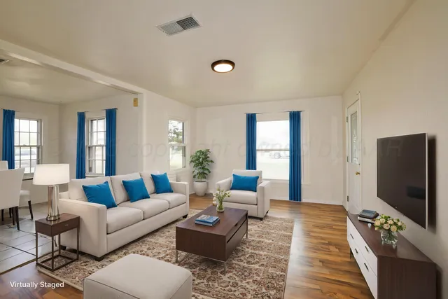 a living room with furniture and a flat screen tv