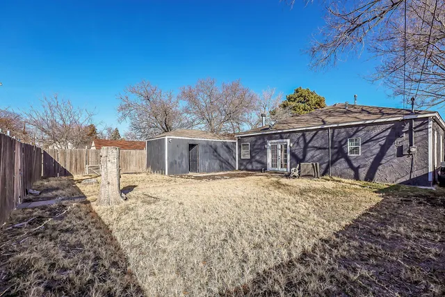 a view of a house with wooden fence