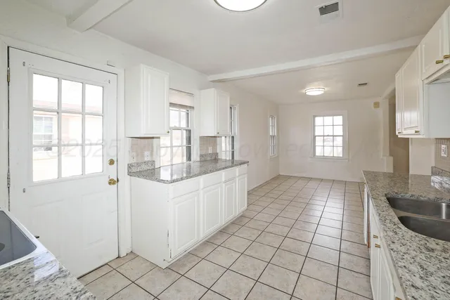 a kitchen with stainless steel appliances granite countertop a sink and a stove