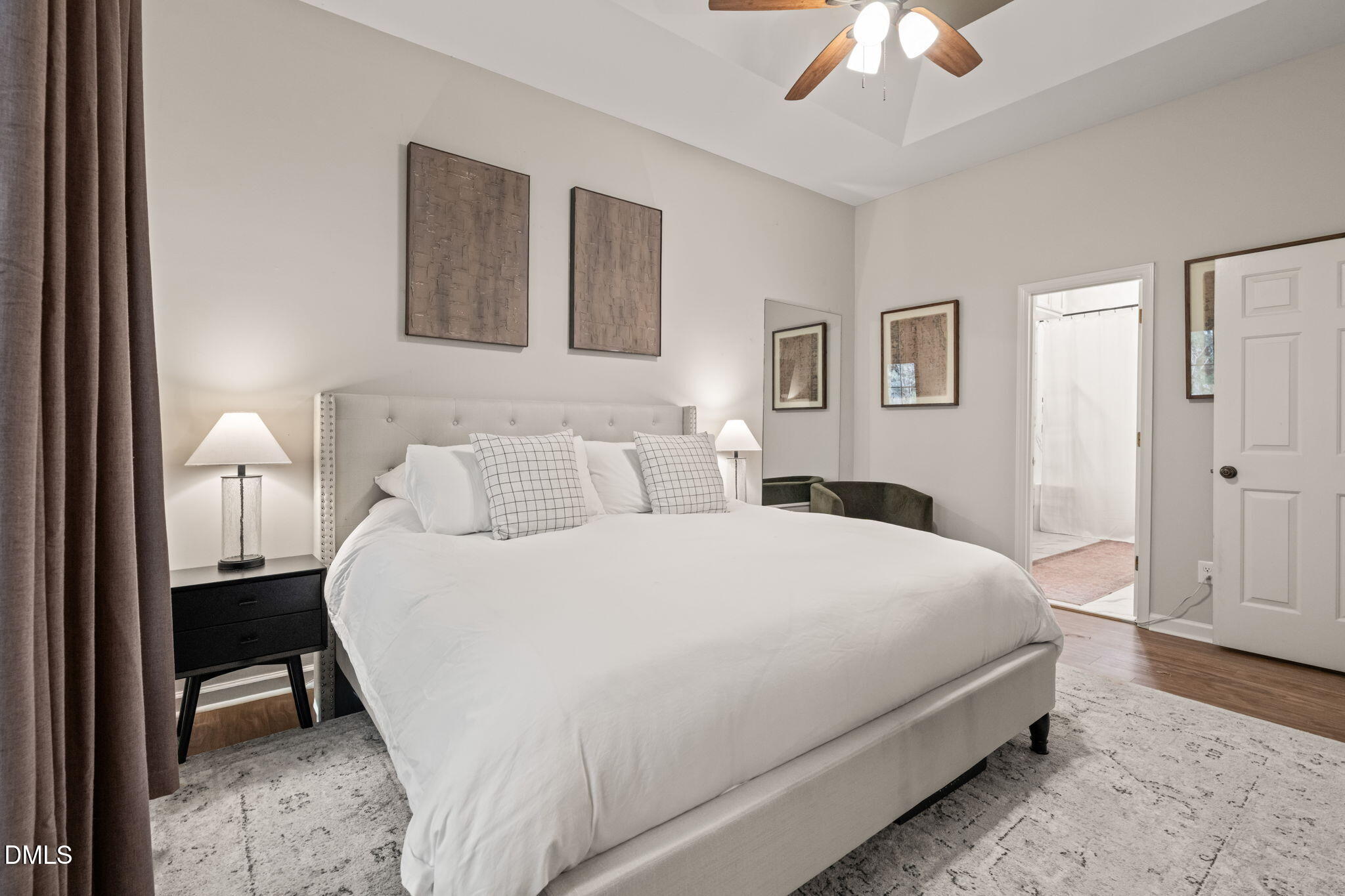 4601 Pine Trace Drive Raleigh, NC 27613 - Photo 12 of 38 a bedroom with a bed and a chandelier