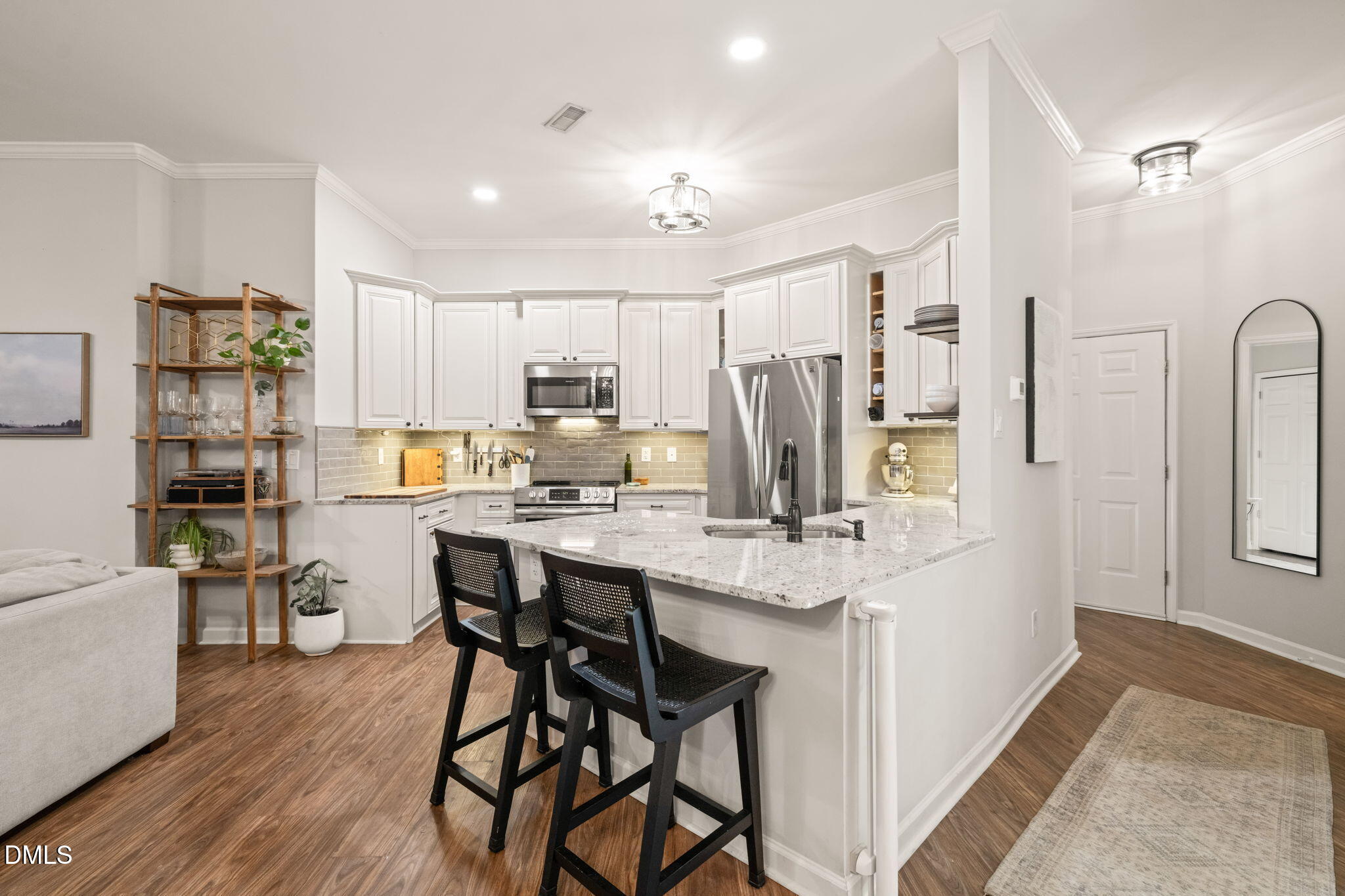 4601 Pine Trace Drive Raleigh, NC 27613 - Photo 4 of 38 a kitchen with stainless steel appliances kitchen island granite countertop a refrigerator and a stove top oven