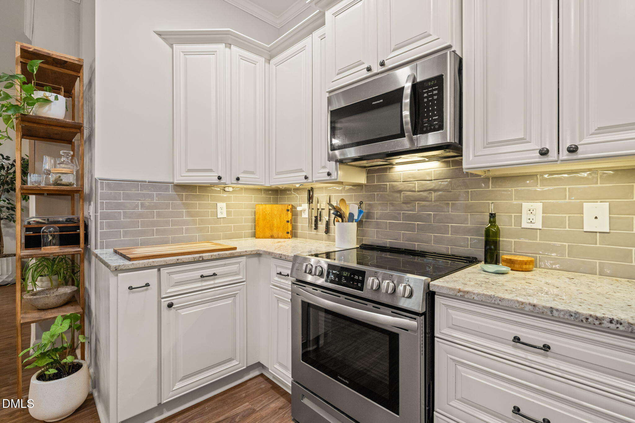 4601 Pine Trace Drive Raleigh, NC 27613 - Photo 6 of 38 a kitchen with stainless steel appliances granite countertop a stove a microwave and cabinets