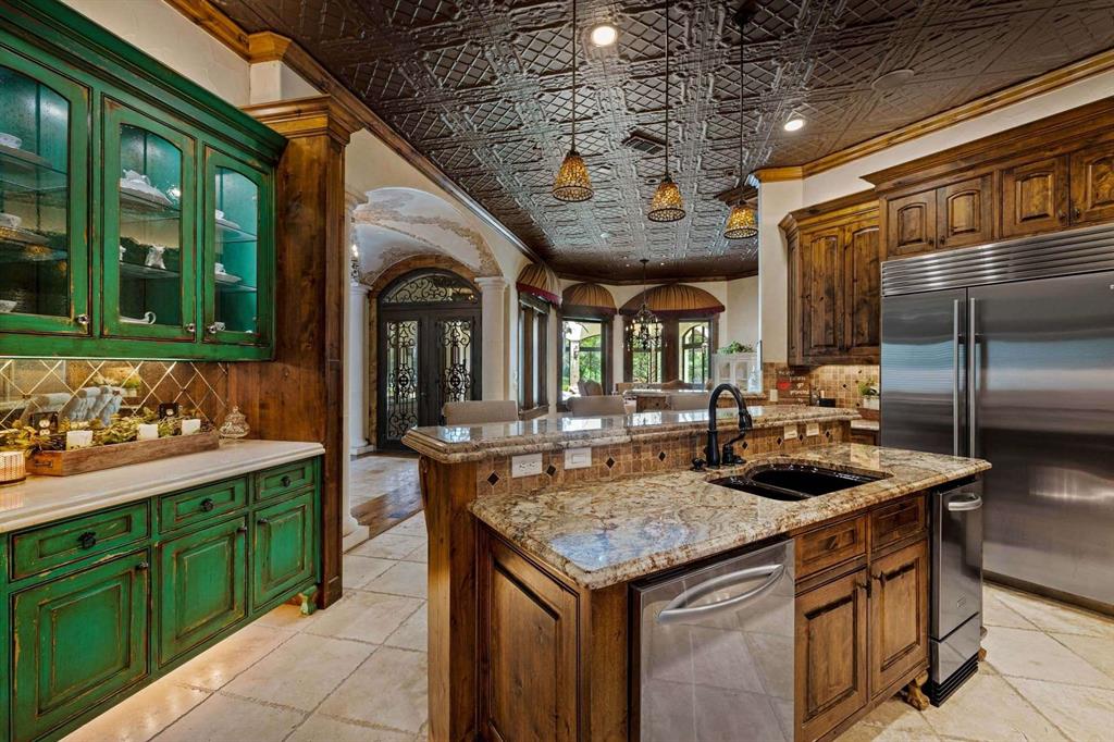 2115 Paradise Rnch Trail McKinney, TX 75071 - Photo 25 of 40 Custom kitchen featuring a decorative tin ceiling, distressed green cabinetry with glass fronts, and wood-finish cabinetry