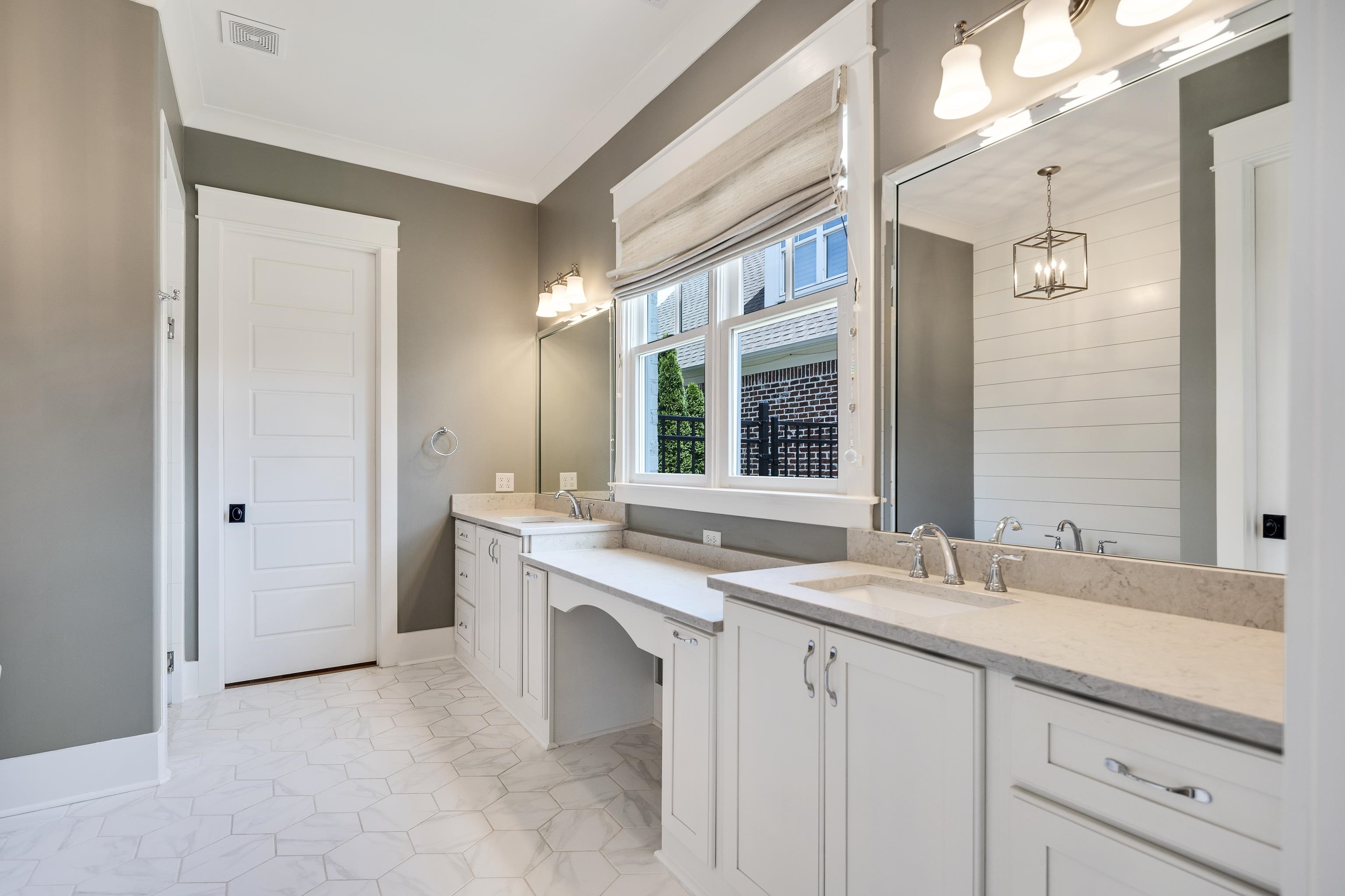 100 Sunflower View Road Piperton, TN 38017 - Photo 19 of 29 Dual vanity with white cabinetry and light-toned countertops