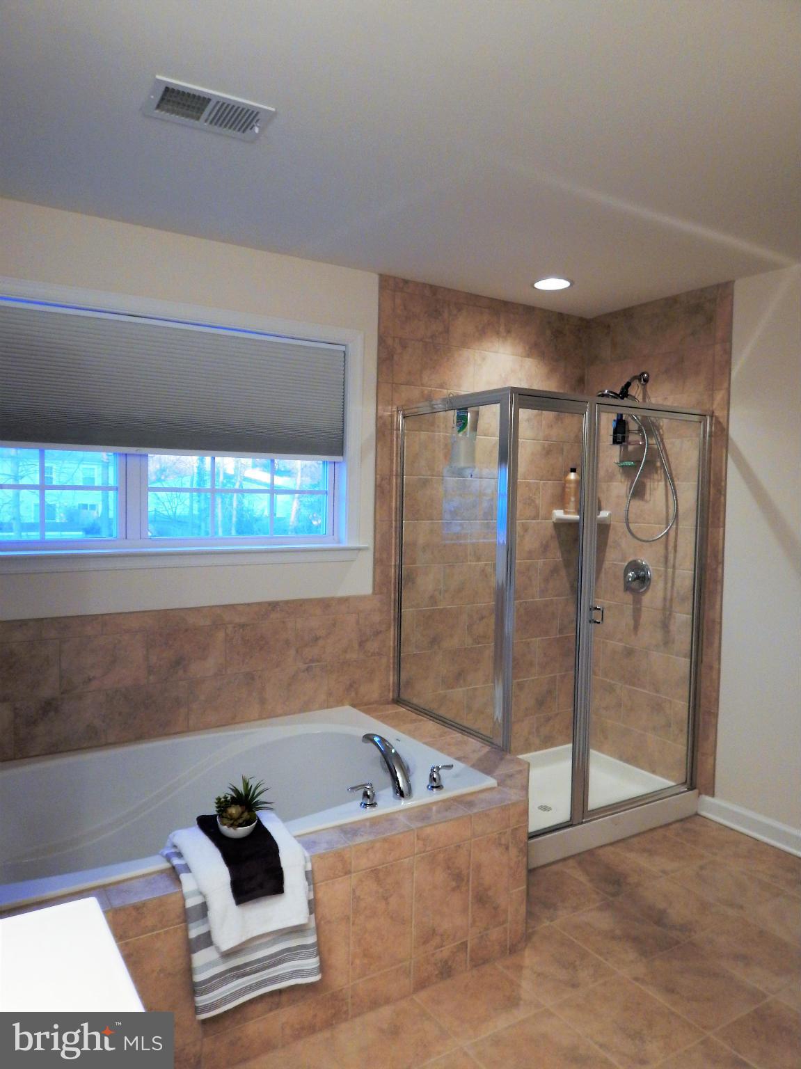 8254 Quarterfield Road Severn, MD 21144 - Photo 16 of 30 a bathroom with a tub and a shower