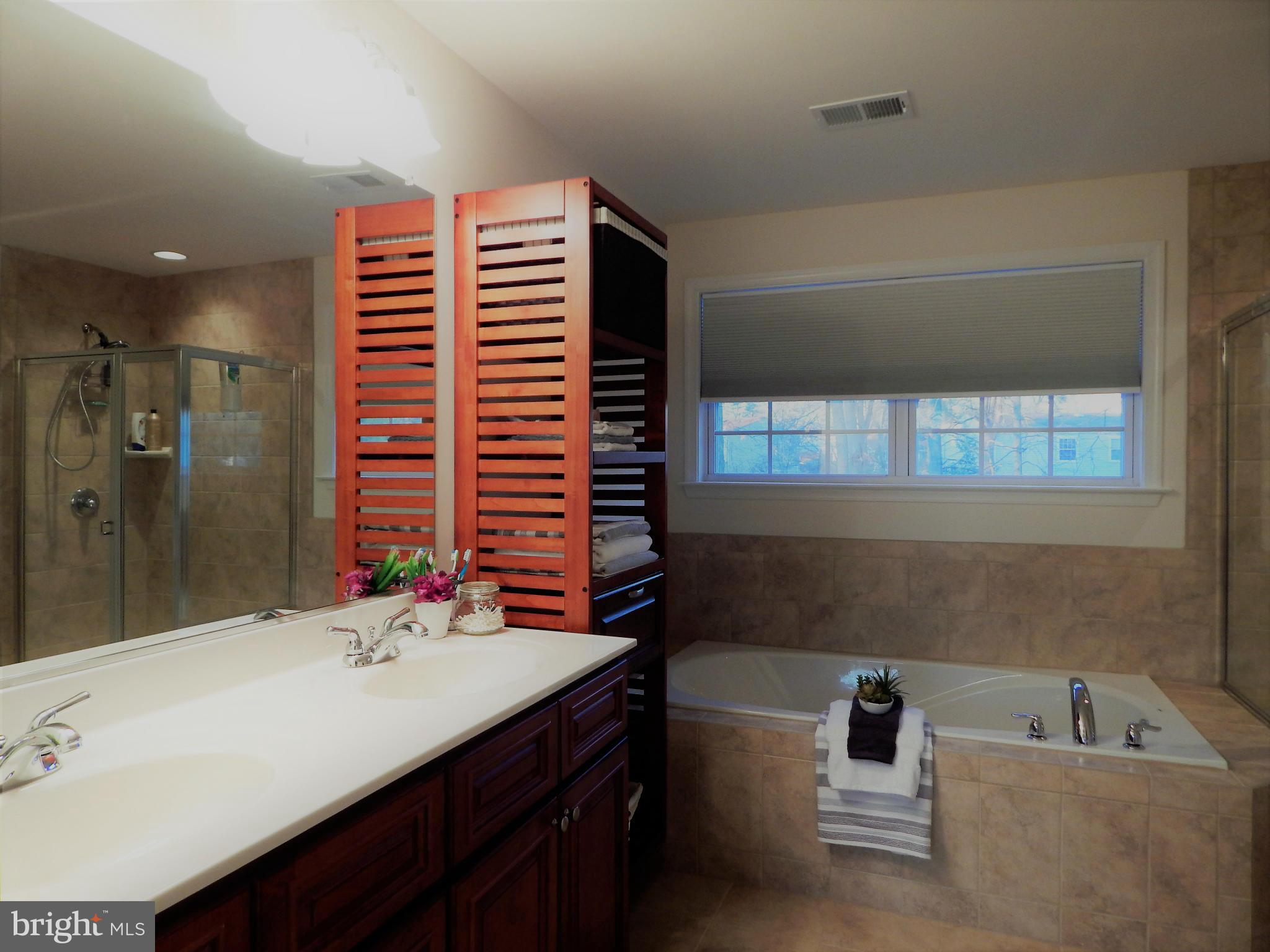 8254 Quarterfield Road Severn, MD 21144 - Photo 17 of 30 a bathroom with a sink double vanity and a bathtub