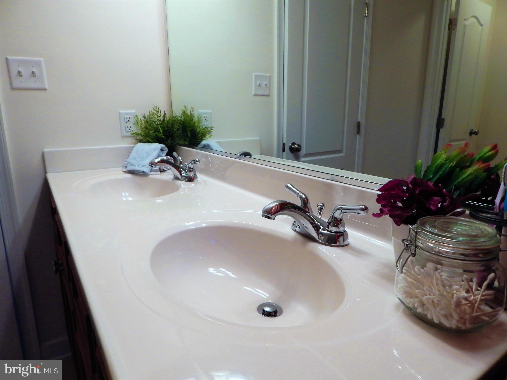 8254 Quarterfield Road Severn, MD 21144 - Photo 18 of 30 a bathroom with a sink a mirror and vanity