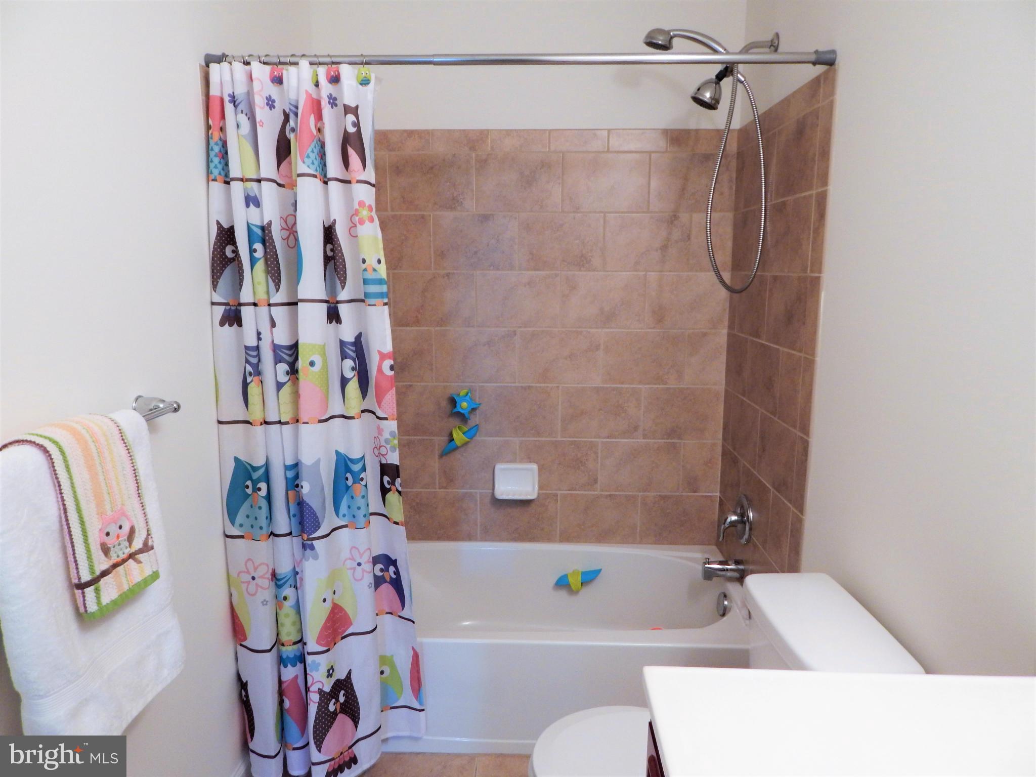 8254 Quarterfield Road Severn, MD 21144 - Photo 22 of 30 a bathroom with a bathtub and a shower