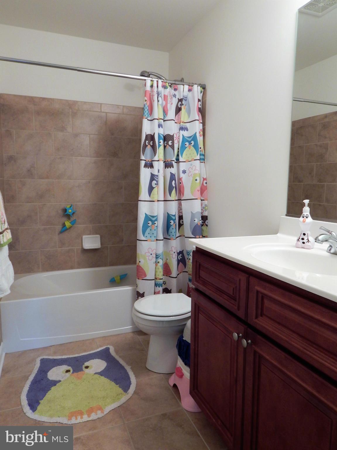 8254 Quarterfield Road Severn, MD 21144 - Photo 23 of 30 a bathroom with a sink a bathtub and a toilet