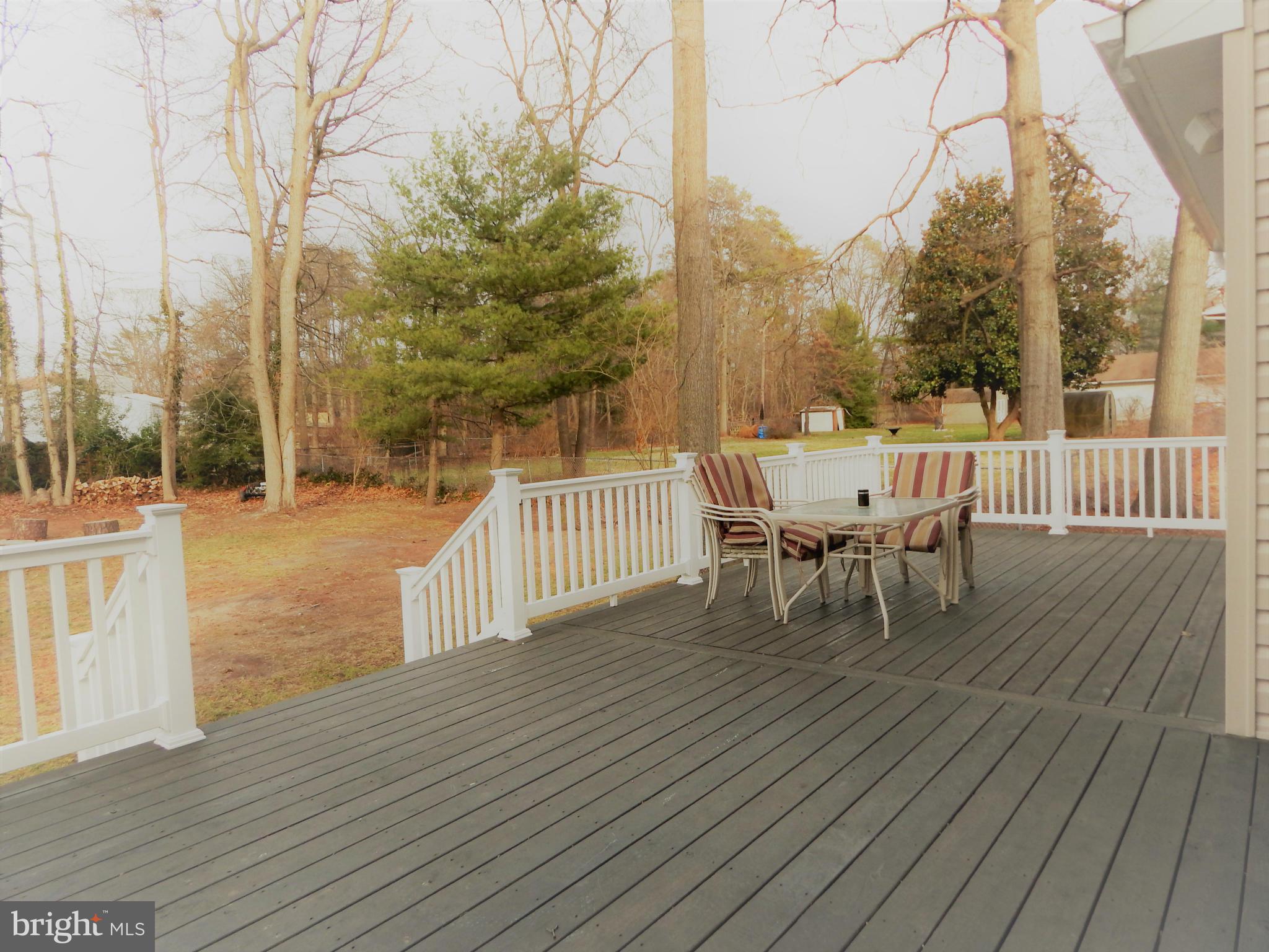 8254 Quarterfield Road Severn, MD 21144 - Photo 30 of 30 a view of a roof deck with table and chairs and wooden floor