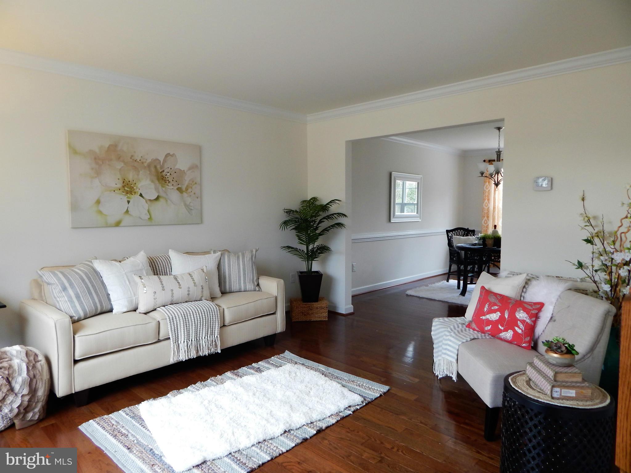 8254 Quarterfield Road Severn, MD 21144 - Photo 4 of 30 a living room with furniture and wooden floor