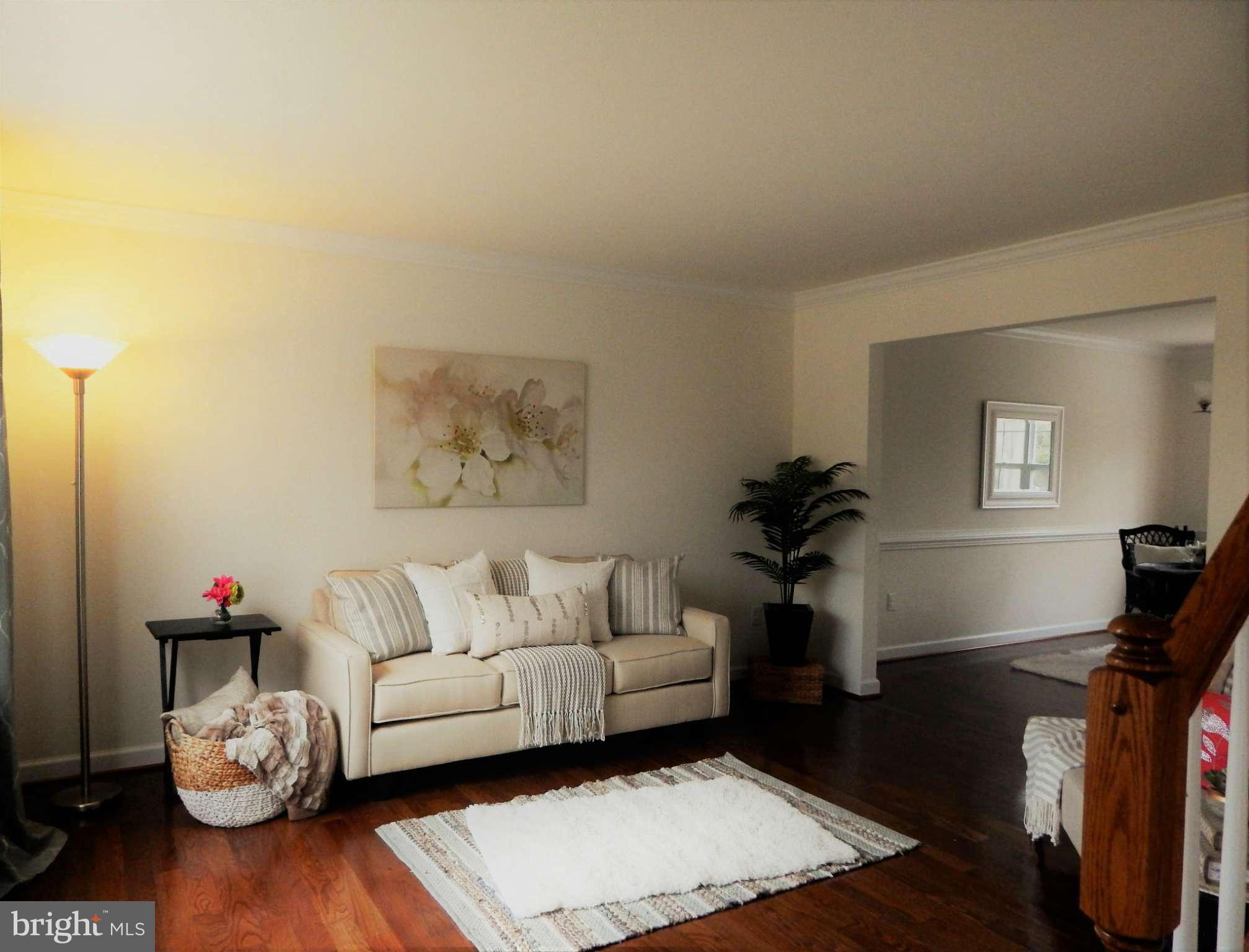 8254 Quarterfield Road Severn, MD 21144 - Photo 5 of 30 a living room with furniture and wooden floor