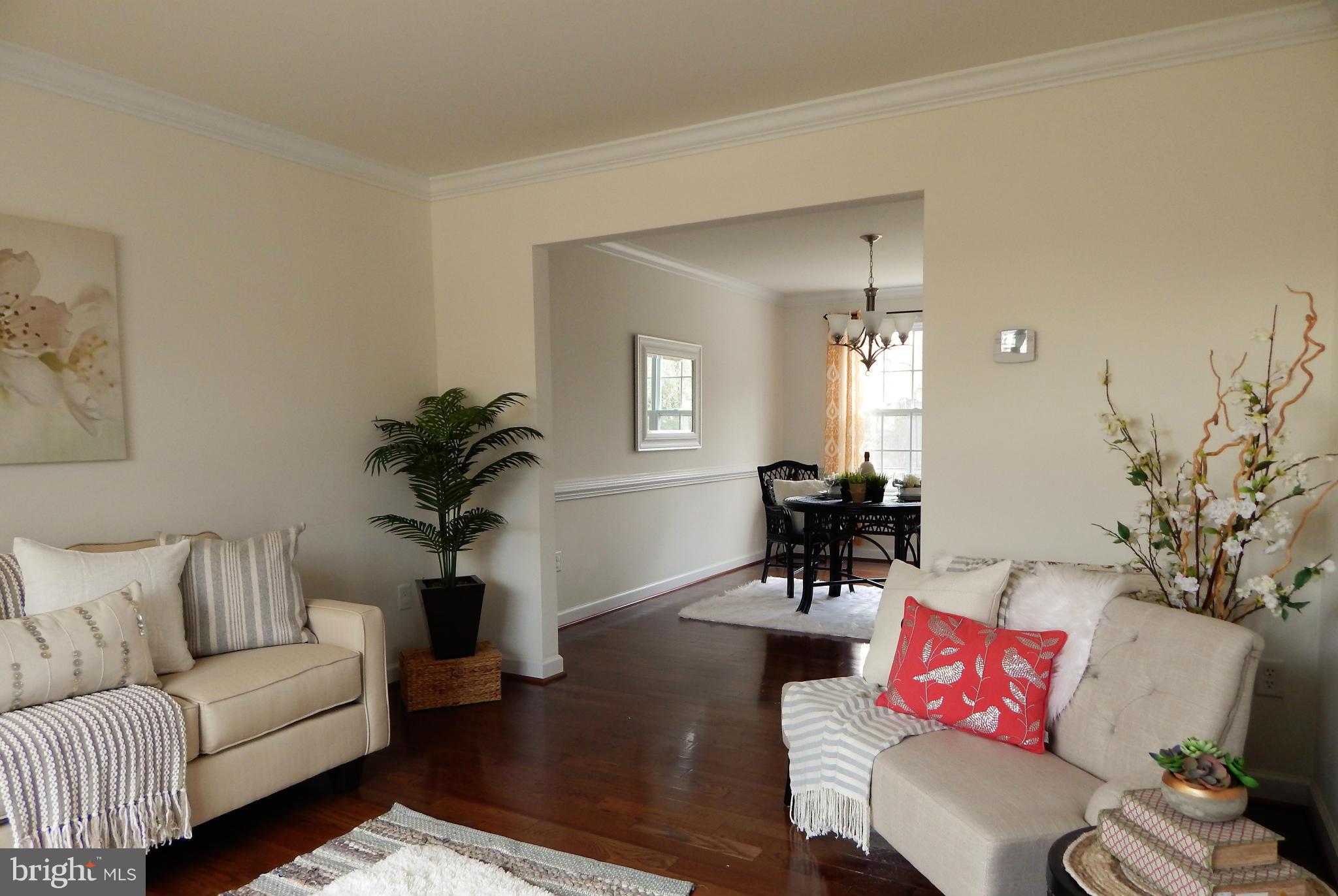 8254 Quarterfield Road Severn, MD 21144 - Photo 6 of 30 a living room with furniture and wooden floor