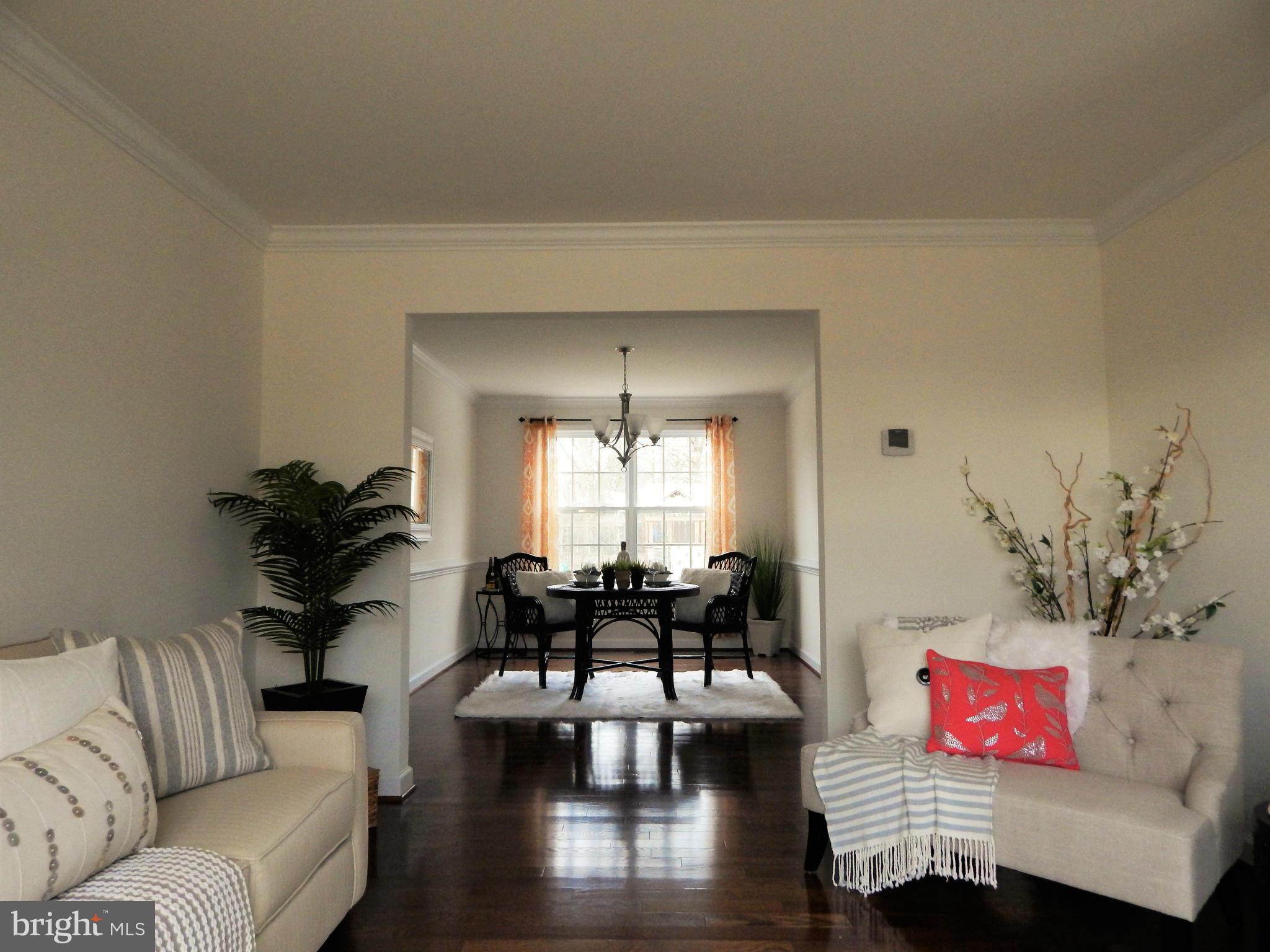 8254 Quarterfield Road Severn, MD 21144 - Photo 7 of 30 a living room with furniture and a chandelier