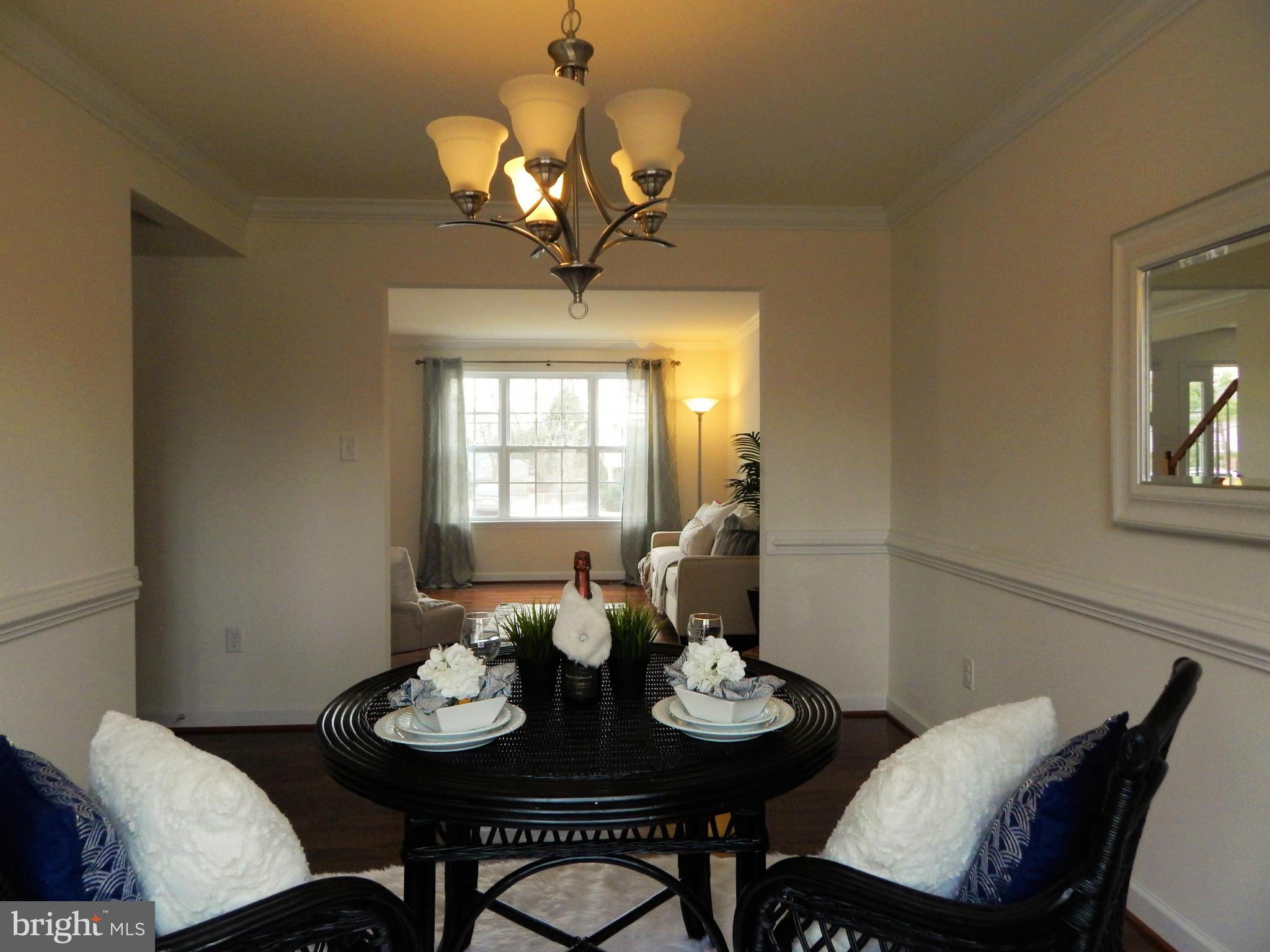 8254 Quarterfield Road Severn, MD 21144 - Photo 8 of 30 a view of a dining room with furniture and chandelier