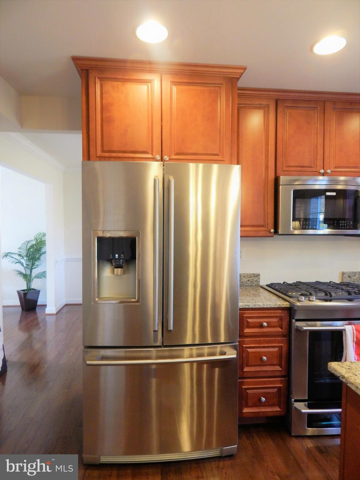 8254 Quarterfield Road Severn, MD 21144 - Photo 10 of 30 a metallic refrigerator freezer sitting in a kitchen