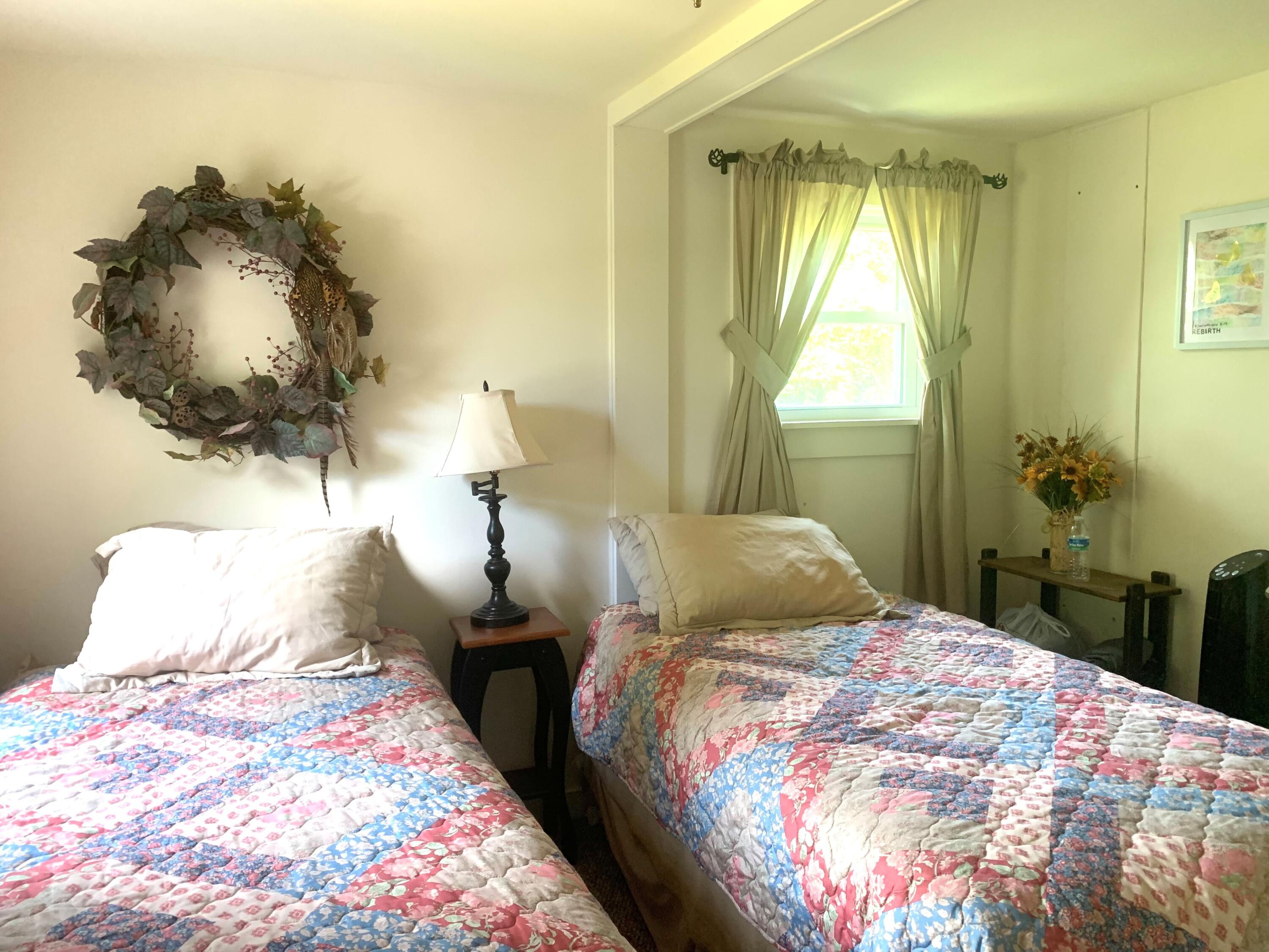 139 Pecks Pond Road Dingmans Ferry, PA 18328 - Photo 11 of 26 a bedroom with a bed and a chandelier