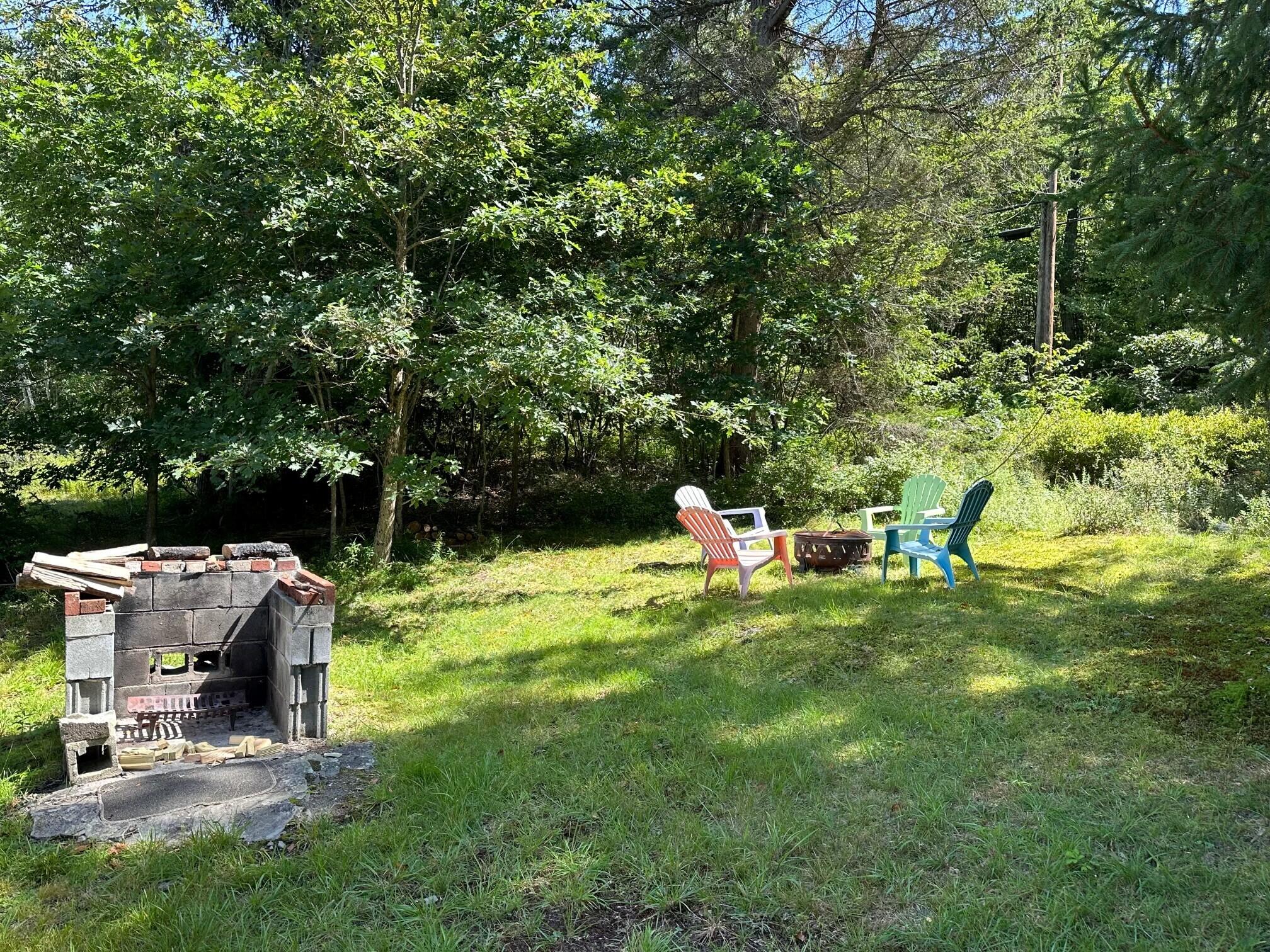 139 Pecks Pond Road Dingmans Ferry, PA 18328 - Photo 17 of 26 a backyard of a house with table and chairs