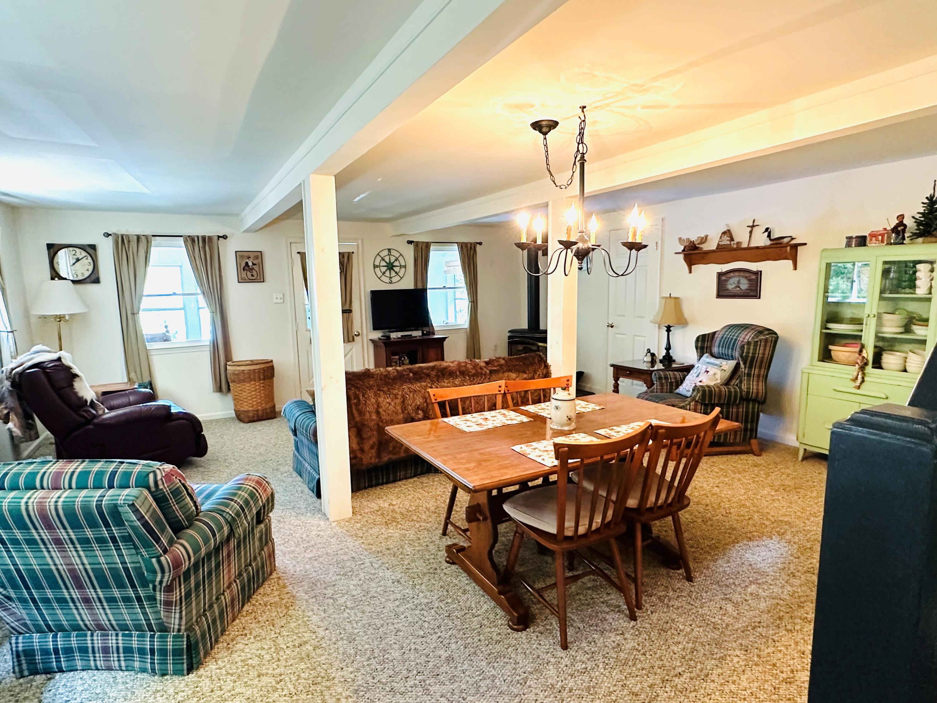 139 Pecks Pond Road Dingmans Ferry, PA 18328 - Photo 5 of 26 a dining room with furniture a chandelier and wooden floor